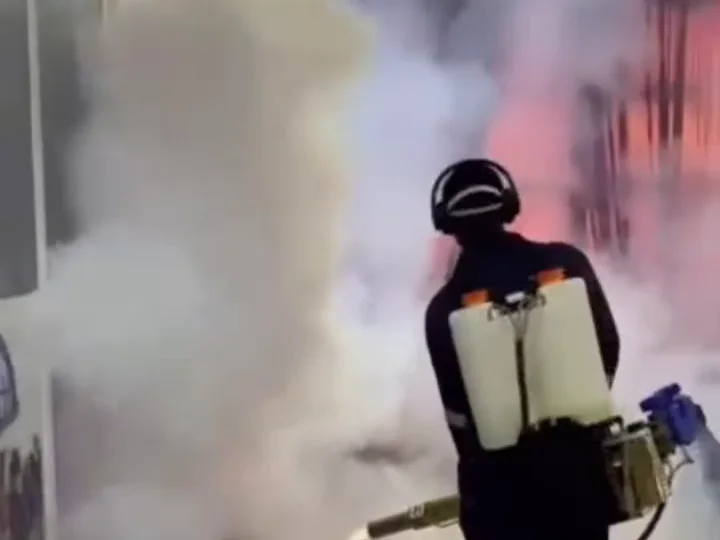 An Ewaso technician fogging with a backpack sprayer