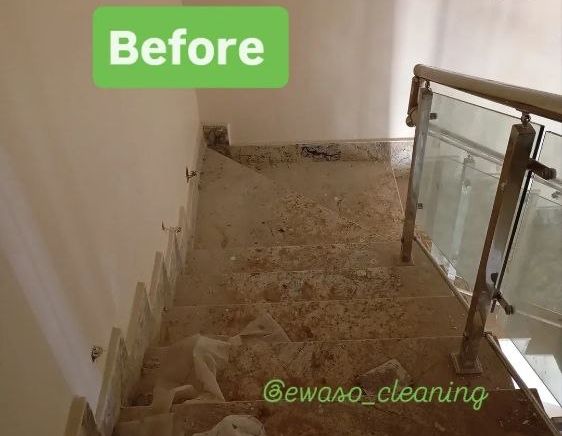 Staircase before cleaning, covered in dust and building debris